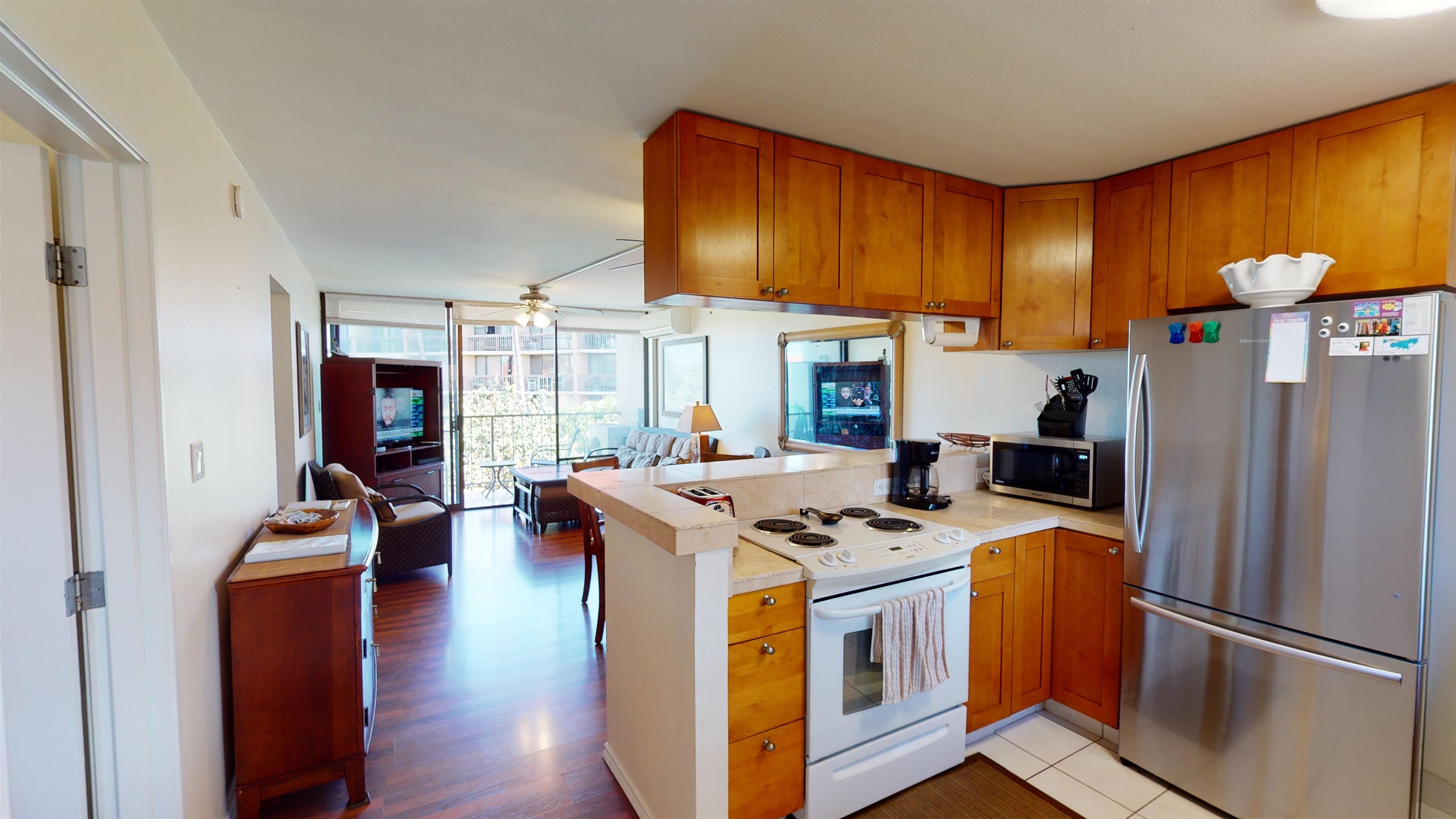 2219 South Kihei Road, Unit A408 Kihei, HI 96753 - Photo 18 of 30 a kitchen with stainless steel appliances granite countertop a stove and a refrigerator