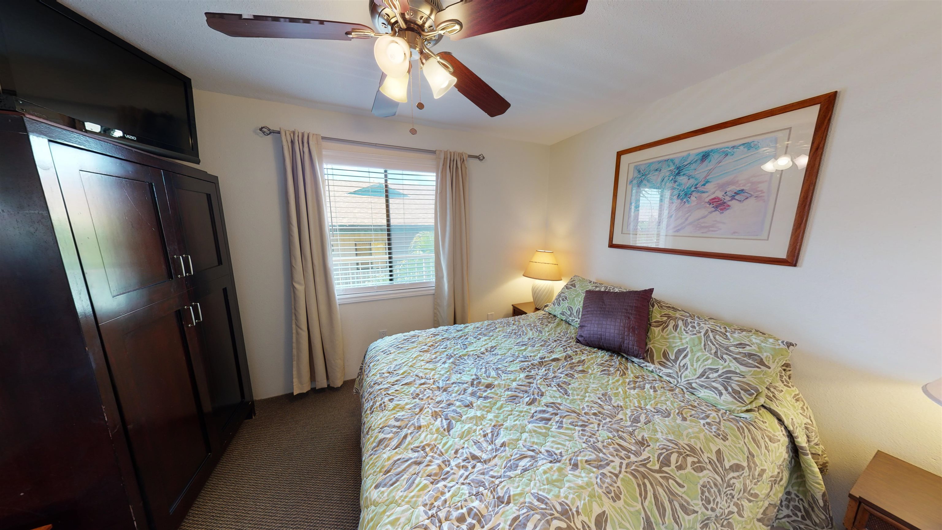 2219 South Kihei Road, Unit A408 Kihei, HI 96753 - Photo 20 of 30 a bedroom with a large bed and a chandelier