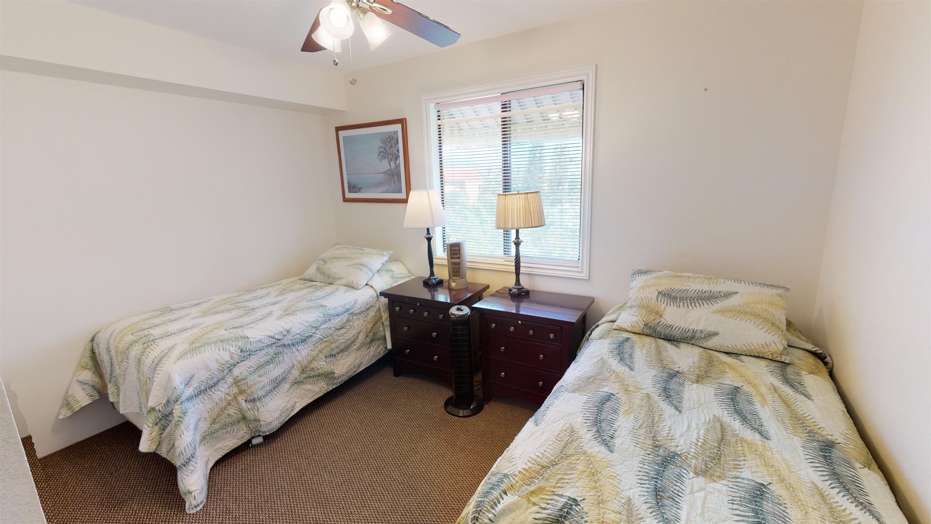 2219 South Kihei Road, Unit A408 Kihei, HI 96753 - Photo 23 of 30 a bedroom with a bed and a chandelier