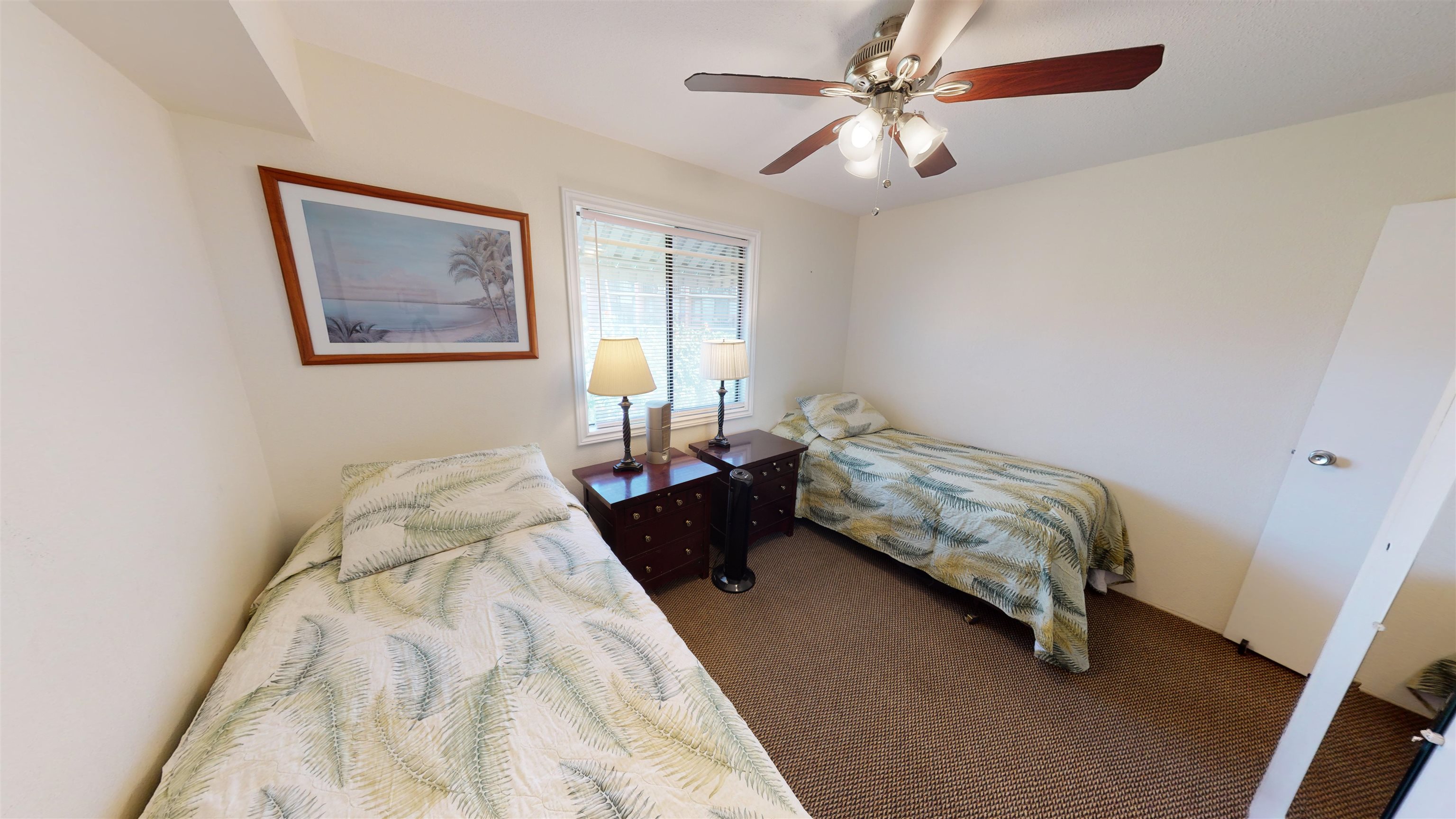2219 South Kihei Road, Unit A408 Kihei, HI 96753 - Photo 24 of 30 a bedroom with a bed and a chandelier