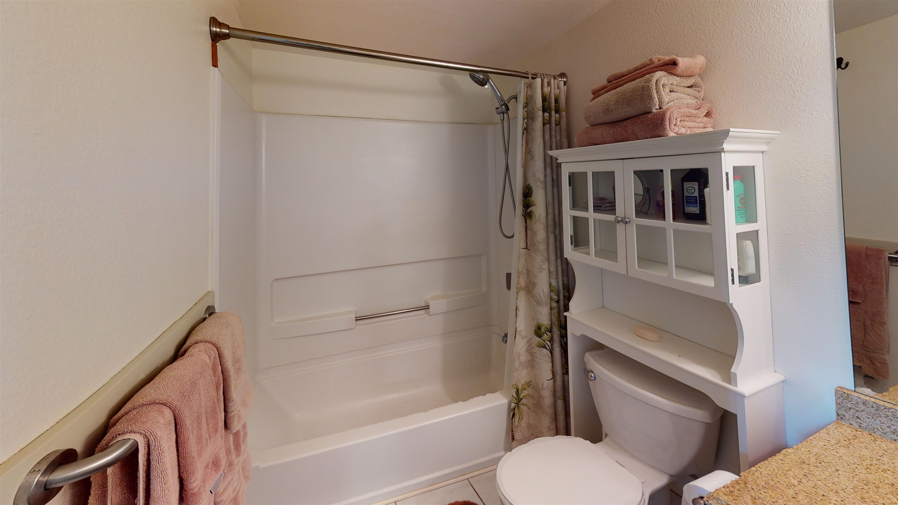 2219 South Kihei Road, Unit A408 Kihei, HI 96753 - Photo 25 of 30 a bathroom with a shower curtain and a toilet