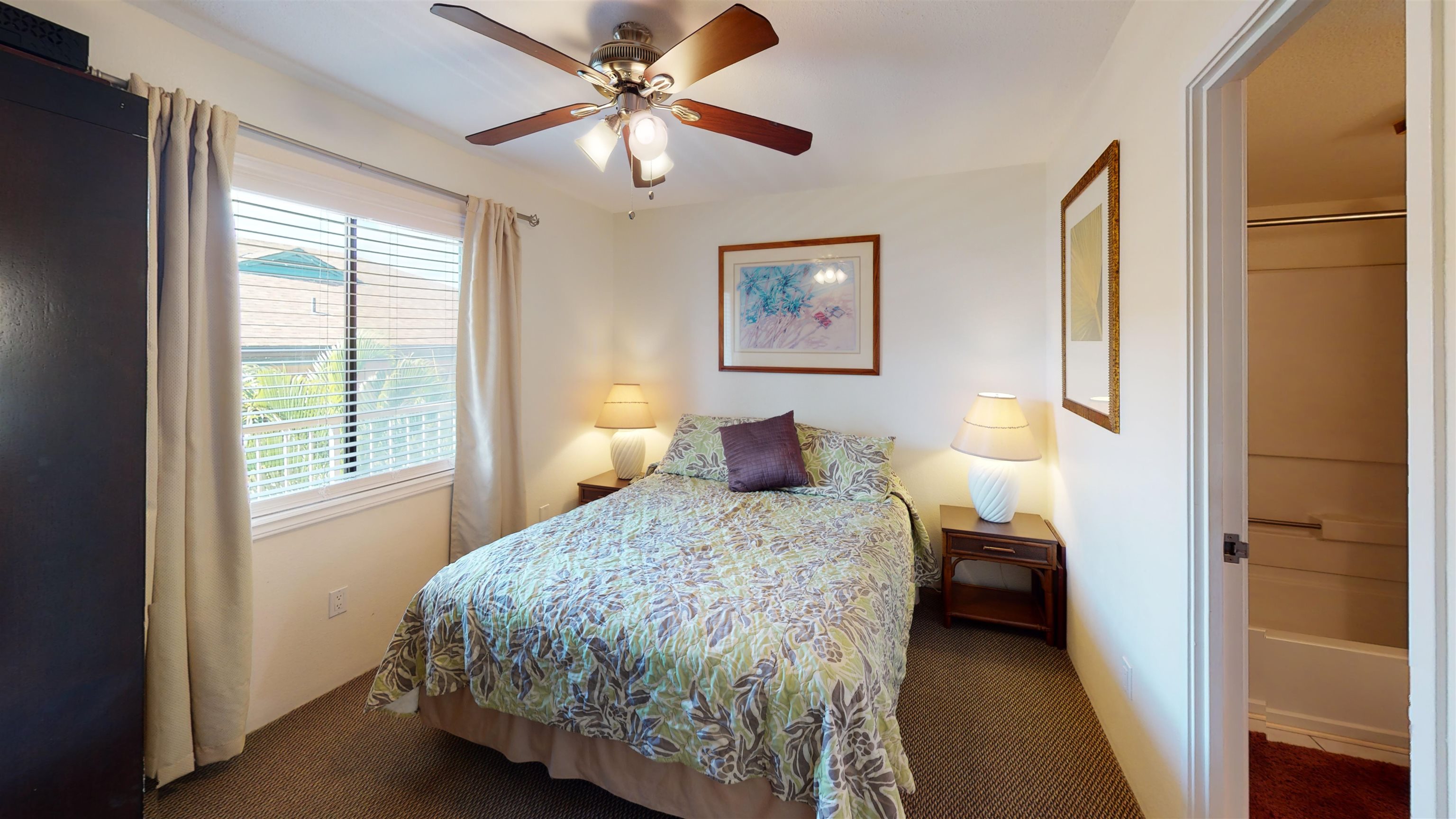 2219 South Kihei Road, Unit A408 Kihei, HI 96753 - Photo 26 of 30 a bedroom with a bed and a chandelier