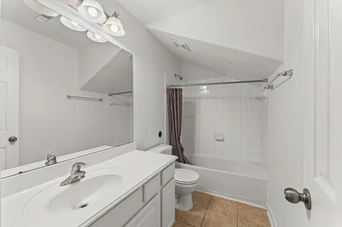 an empty room with windows and ceiling fan