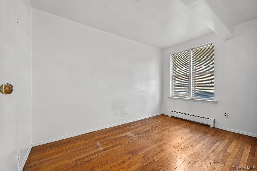 41-30 45th Street Queens, NY 11104 - Photo 4 of 16 wooden floor in an empty room