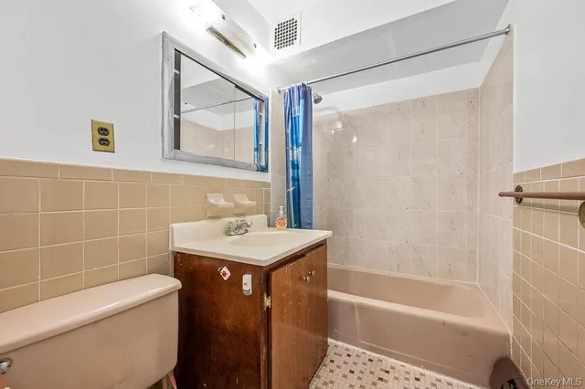 a bathroom with a sink mirror toilet and bathtub