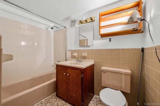 a bathroom with a sink a toilet and bathtub