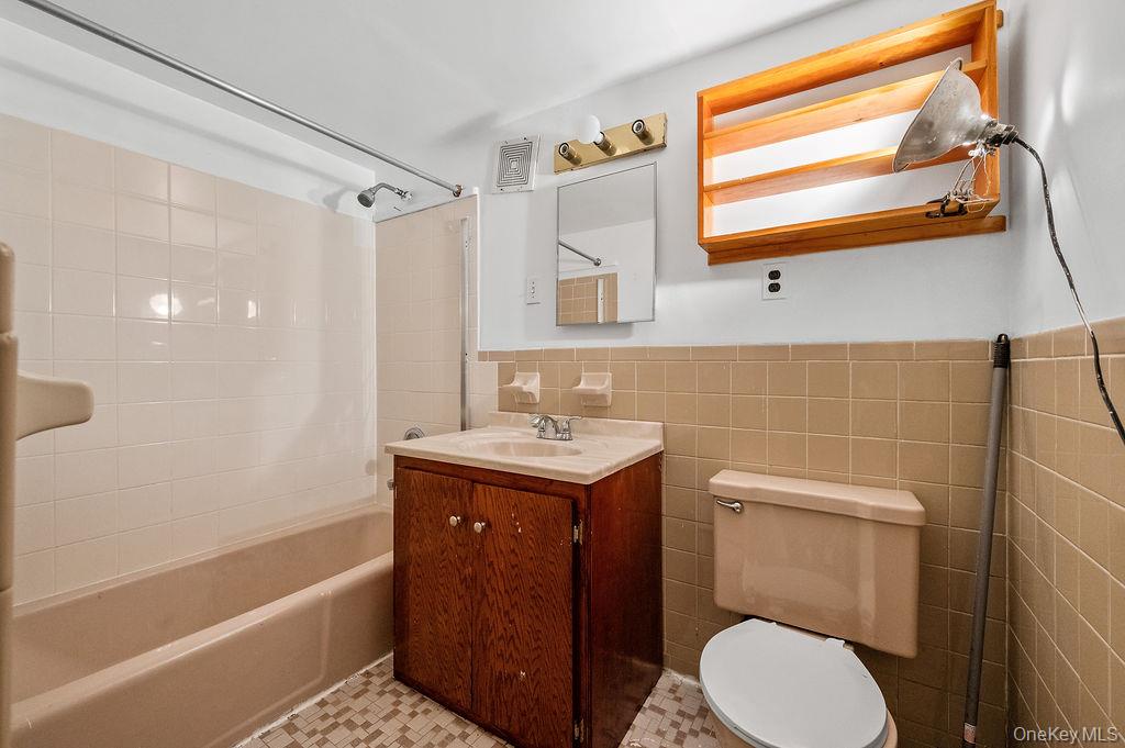 41-30 45th Street Queens, NY 11104 - Photo 10 of 16 a bathroom with a sink a toilet and bathtub