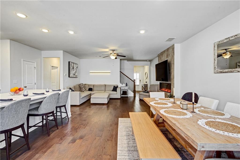 3434 Senna Road Duluth, GA 30096 - Photo 13 of 39 a very nice looking living room with dining room and wooden floor