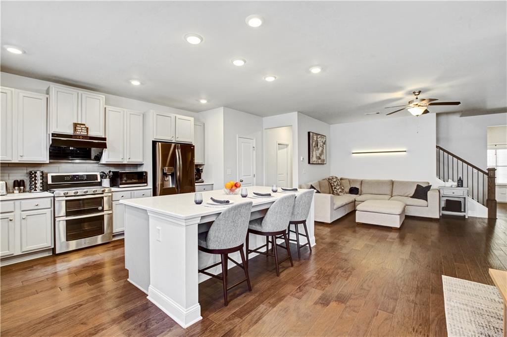 3434 Senna Road Duluth, GA 30096 - Photo 14 of 39 a living room with stainless steel appliances furniture and a view of kitchen