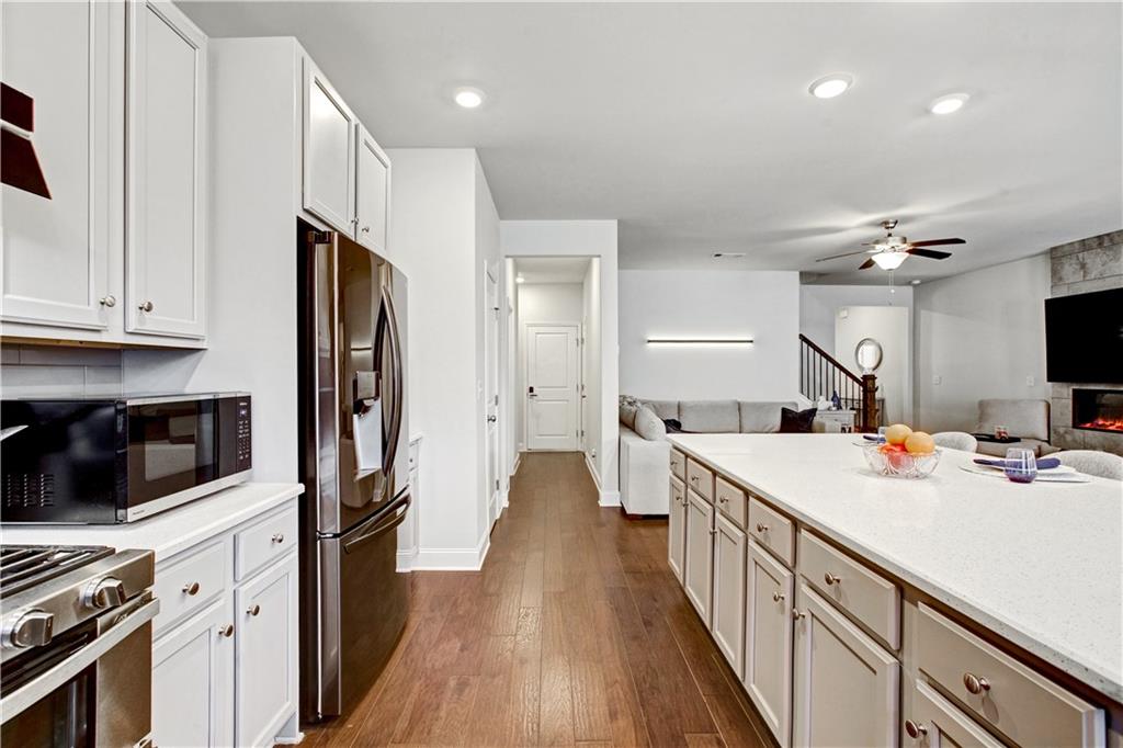 3434 Senna Road Duluth, GA 30096 - Photo 15 of 39 a kitchen with a sink a counter top space stainless steel appliances and cabinets