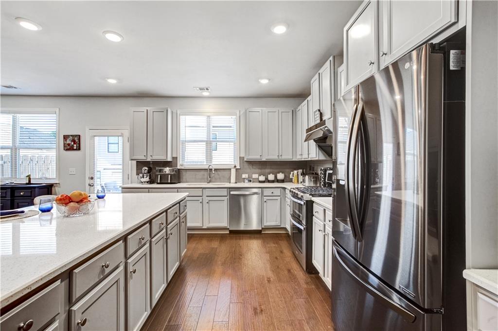 3434 Senna Road Duluth, GA 30096 - Photo 17 of 39 a kitchen with stainless steel appliances a refrigerator sink and cabinets