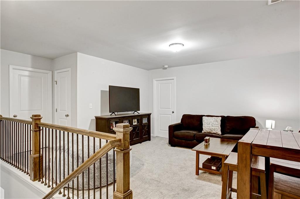 3434 Senna Road Duluth, GA 30096 - Photo 19 of 39 a living room with furniture and a flat screen tv