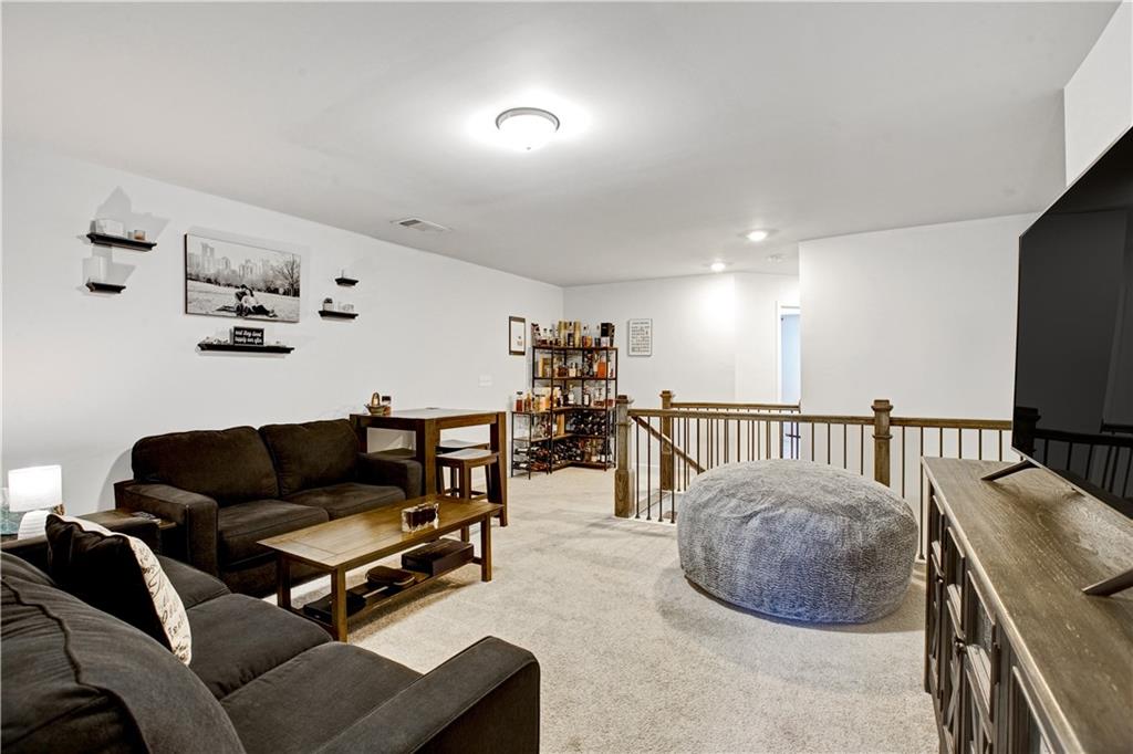 3434 Senna Road Duluth, GA 30096 - Photo 20 of 39 a living room with furniture and a flat screen tv