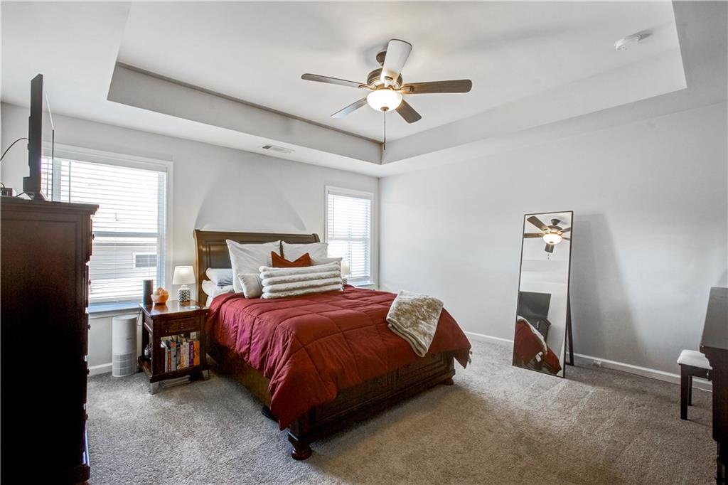 3434 Senna Road Duluth, GA 30096 - Photo 21 of 39 a bedroom with a bed and a ceiling fan