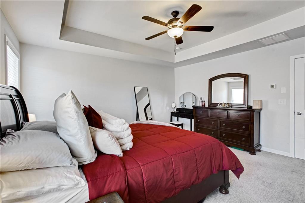 3434 Senna Road Duluth, GA 30096 - Photo 23 of 39 a bedroom with a bed and a chandelier