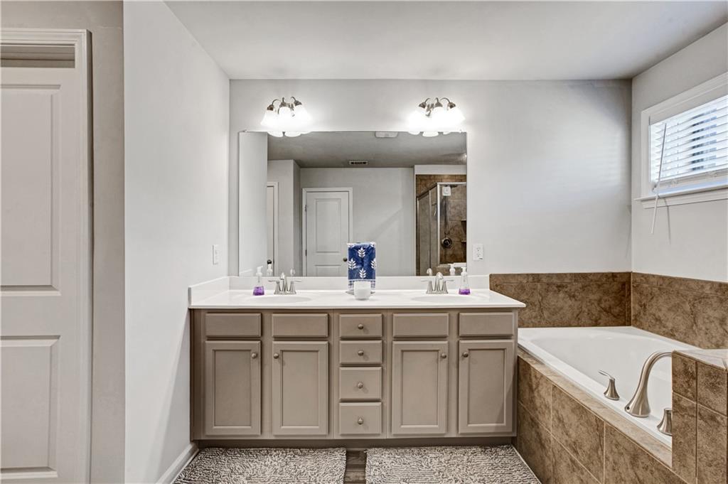3434 Senna Road Duluth, GA 30096 - Photo 25 of 39 a bathroom with a tub sink and mirror