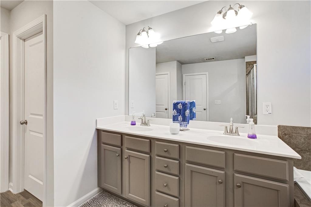 3434 Senna Road Duluth, GA 30096 - Photo 28 of 39 a bathroom with a double vanity sink and a mirror