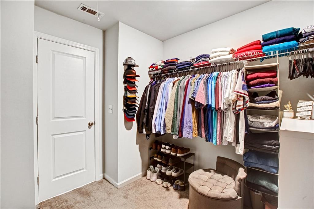 3434 Senna Road Duluth, GA 30096 - Photo 30 of 39 a view of walk in closet with clothes and shoes