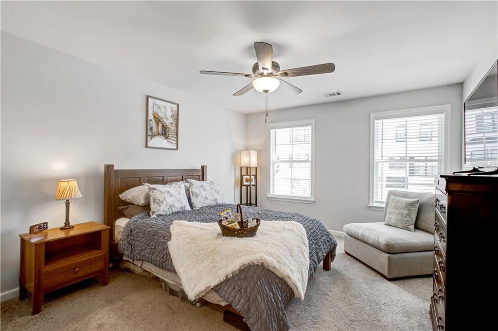 3434 Senna Road Duluth, GA 30096 - Photo 32 of 39 a bedroom with a bed and a couch