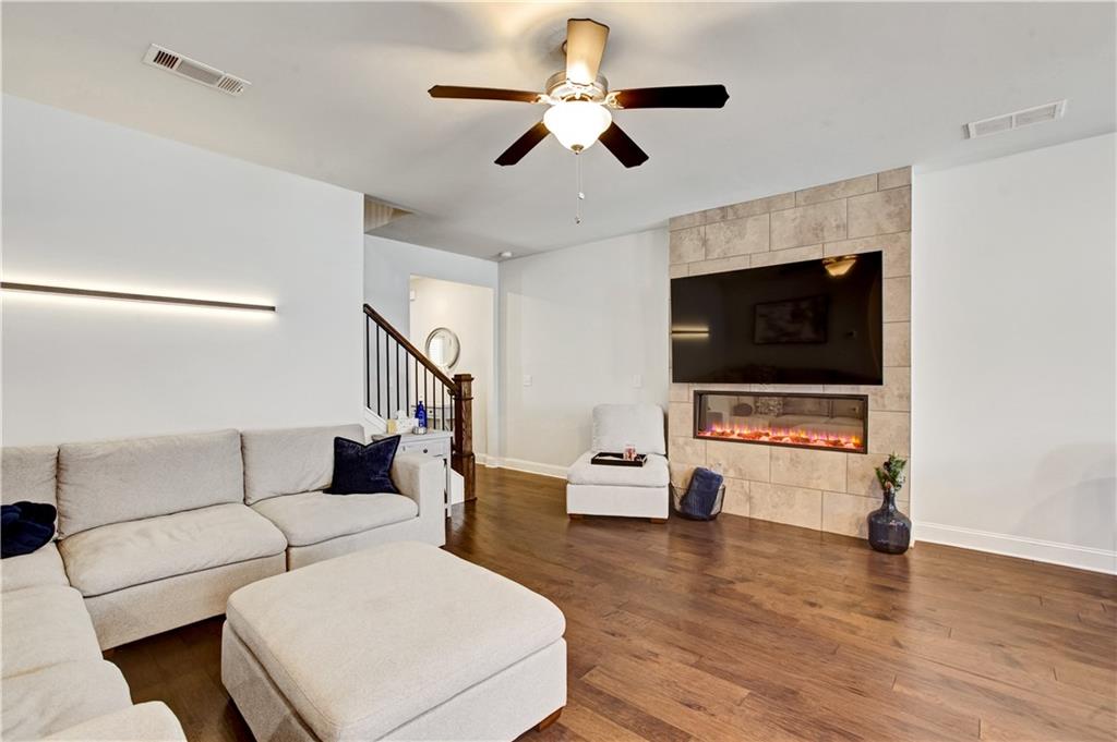 3434 Senna Road Duluth, GA 30096 - Photo 8 of 39 a living room with furniture and a flat screen tv