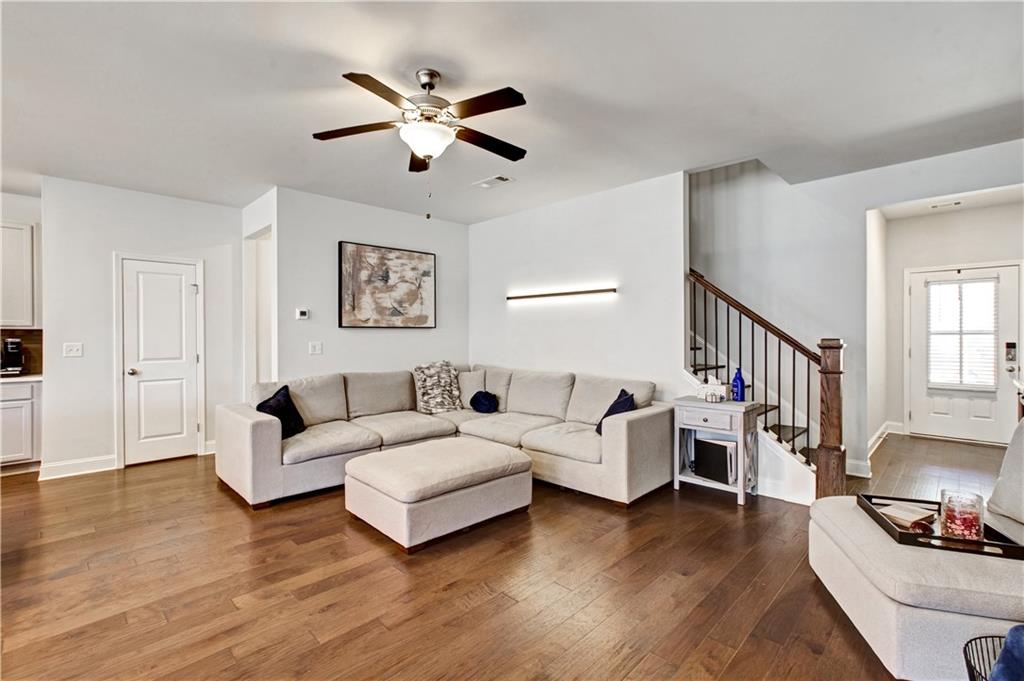 3434 Senna Road Duluth, GA 30096 - Photo 9 of 39 a living room with furniture and a wooden floor