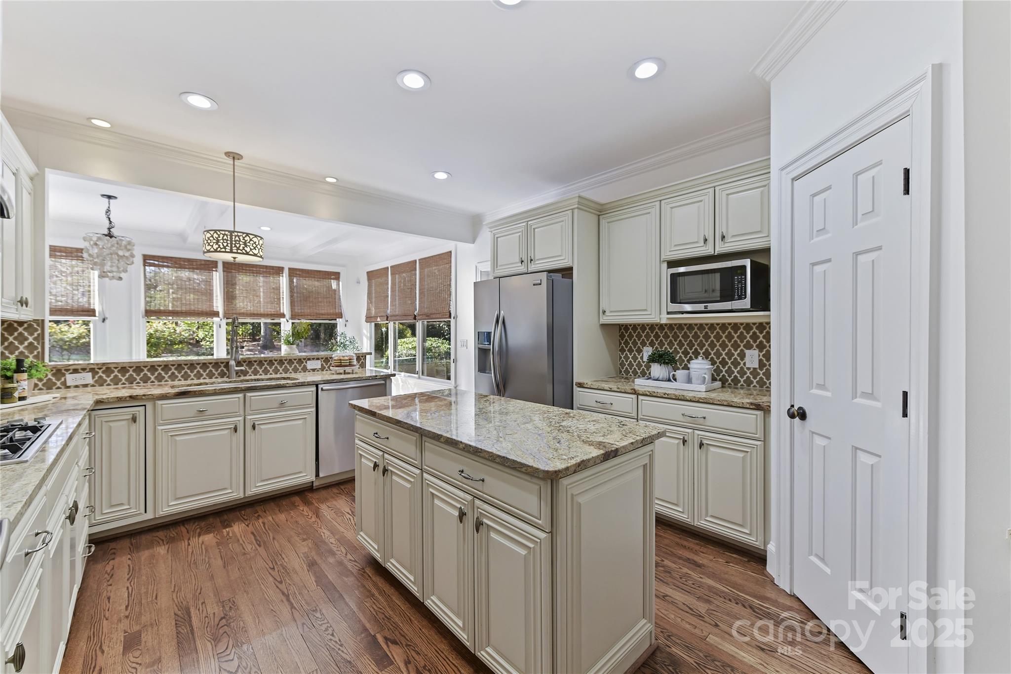 18512 Square Sail Road Cornelius, NC 28031 - Photo 14 of 40 a kitchen with kitchen island granite countertop appliances cabinets and a sink