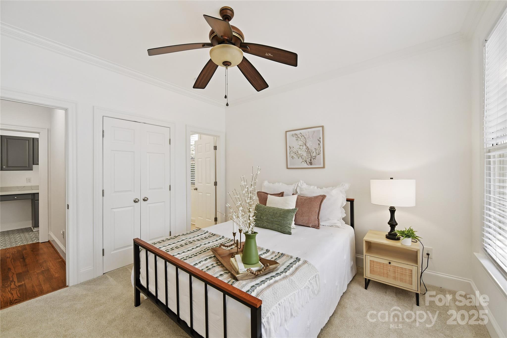 18512 Square Sail Road Cornelius, NC 28031 - Photo 20 of 40 a bedroom with a bed and a chandelier