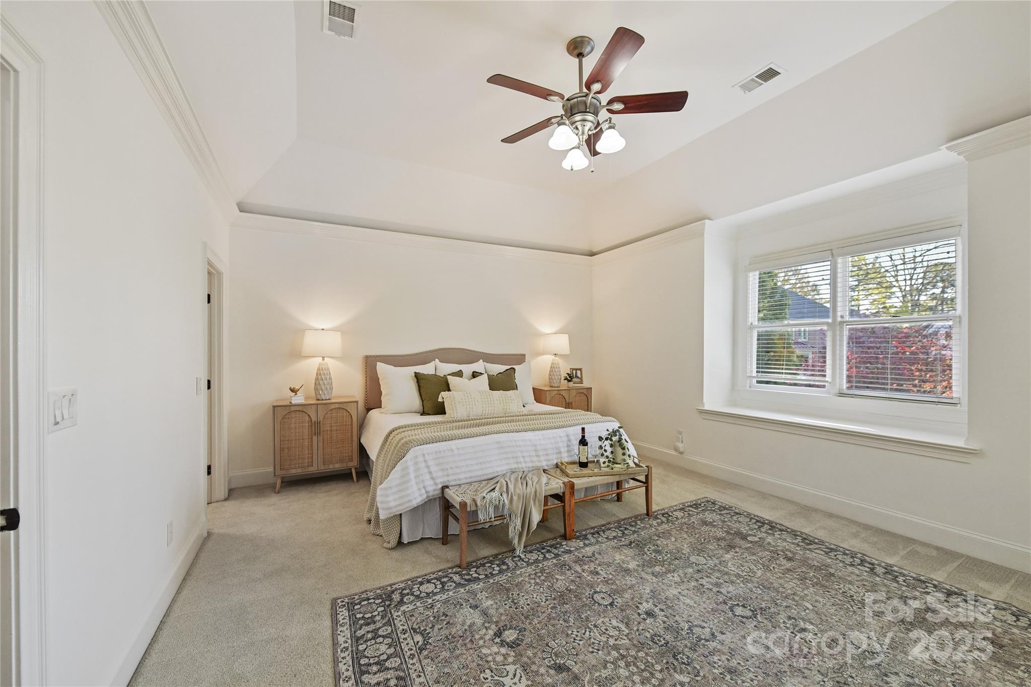 18512 Square Sail Road Cornelius, NC 28031 - Photo 25 of 40 a bedroom with a bed and a chandelier