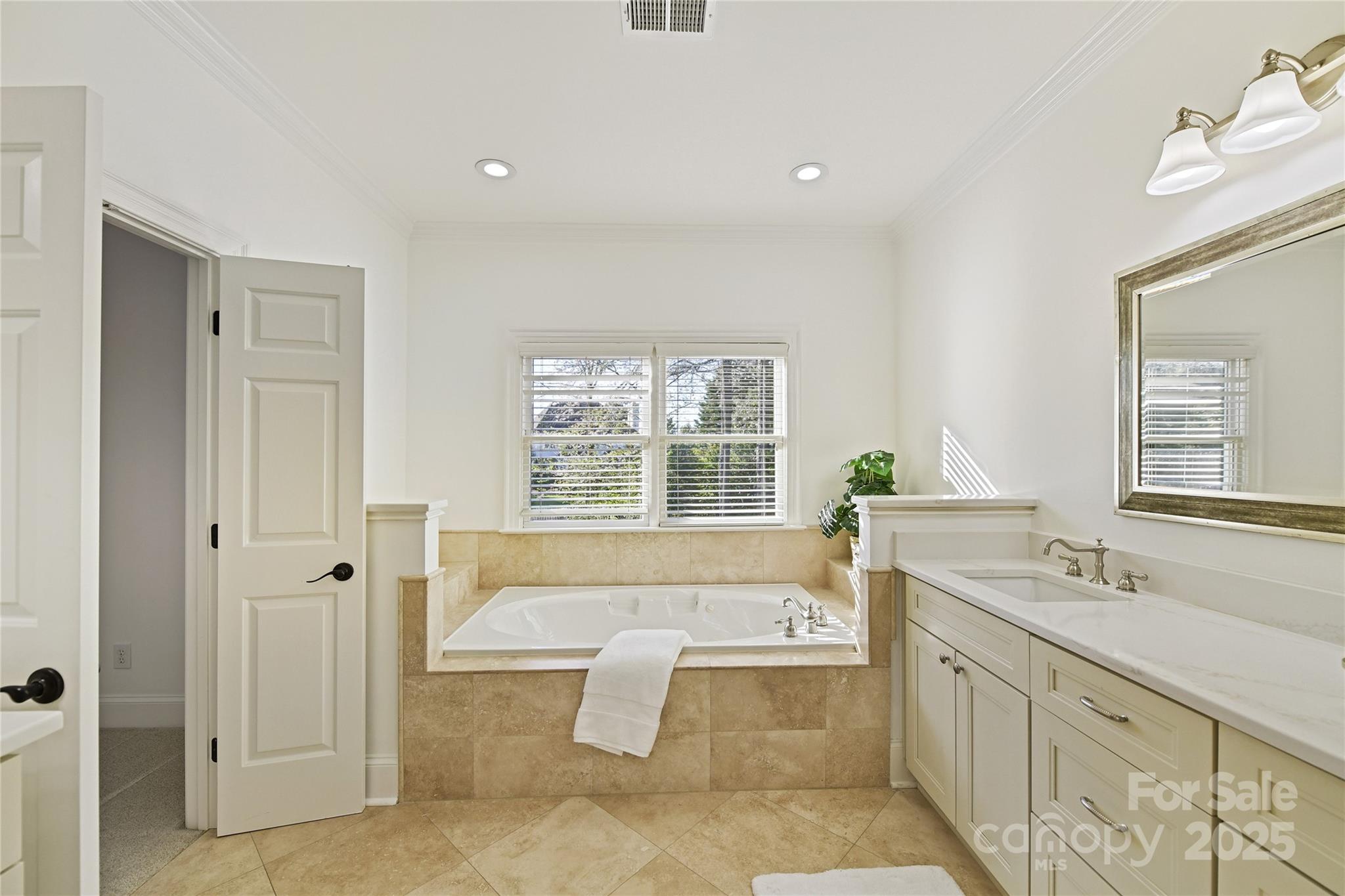 18512 Square Sail Road Cornelius, NC 28031 - Photo 27 of 40 a spacious bathroom with a tub sink and mirror