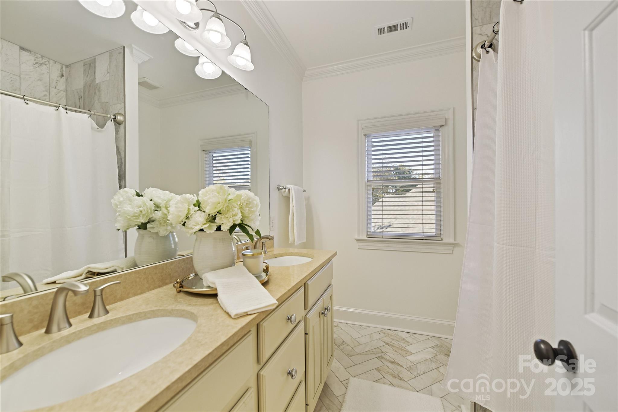 18512 Square Sail Road Cornelius, NC 28031 - Photo 30 of 40 a bathroom with a granite countertop sink a large mirror and a shower