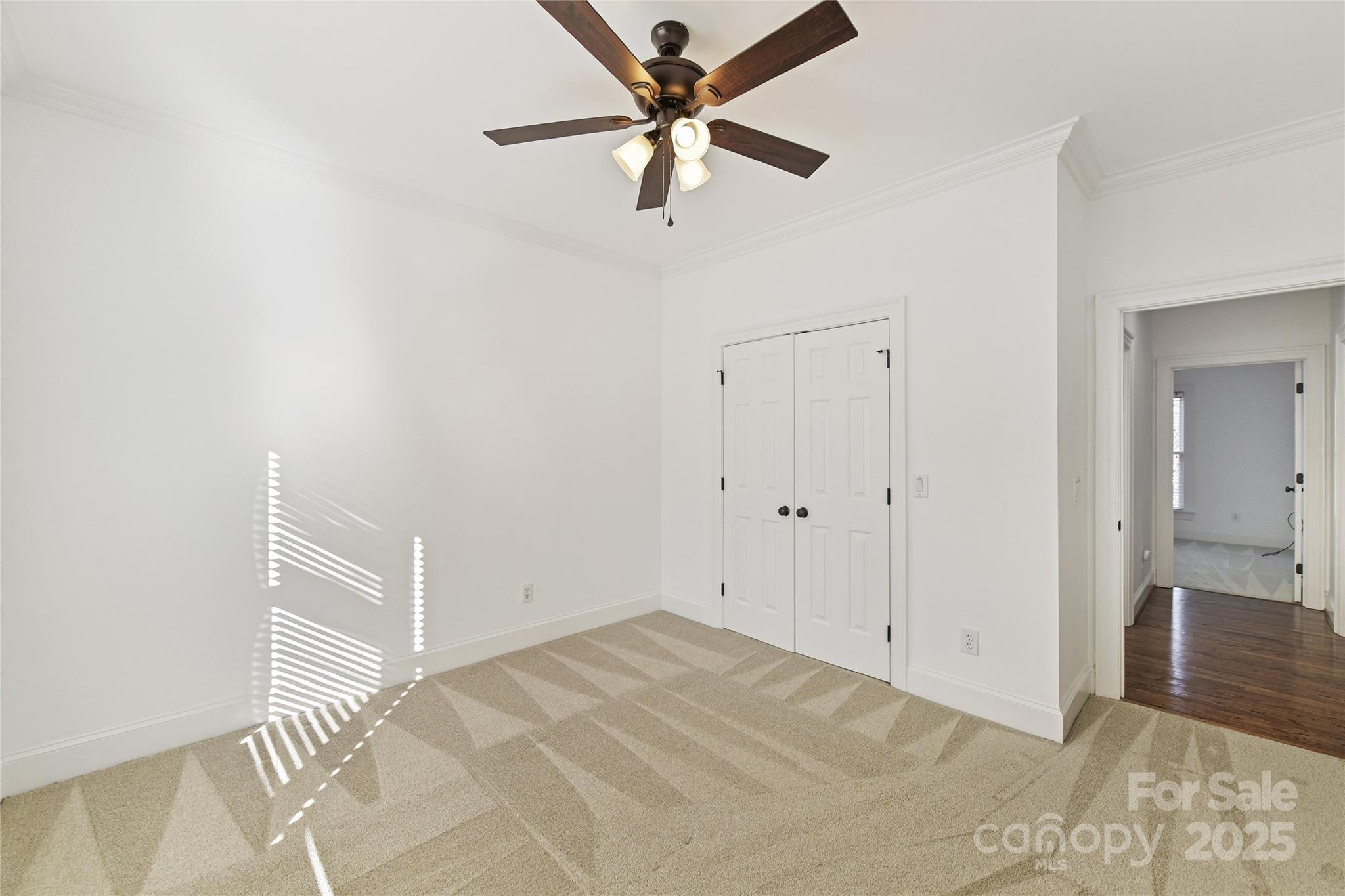 18512 Square Sail Road Cornelius, NC 28031 - Photo 32 of 40 a view of a livingroom with a ceiling fan and wooden floor