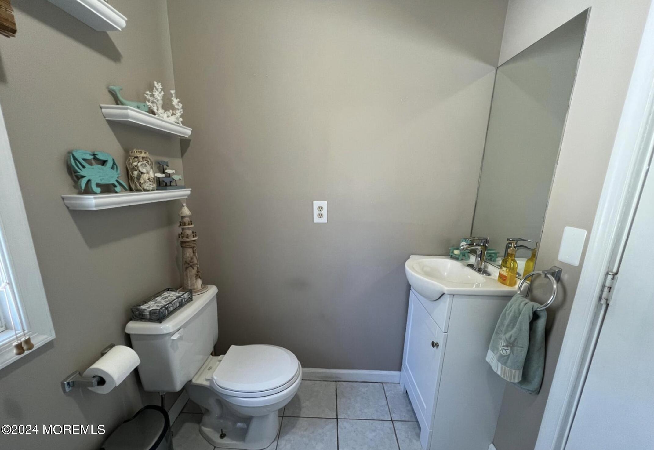 404 Drum Point Road Brick, NJ 08723 - Photo 11 of 22 a bathroom with a toilet and a sink