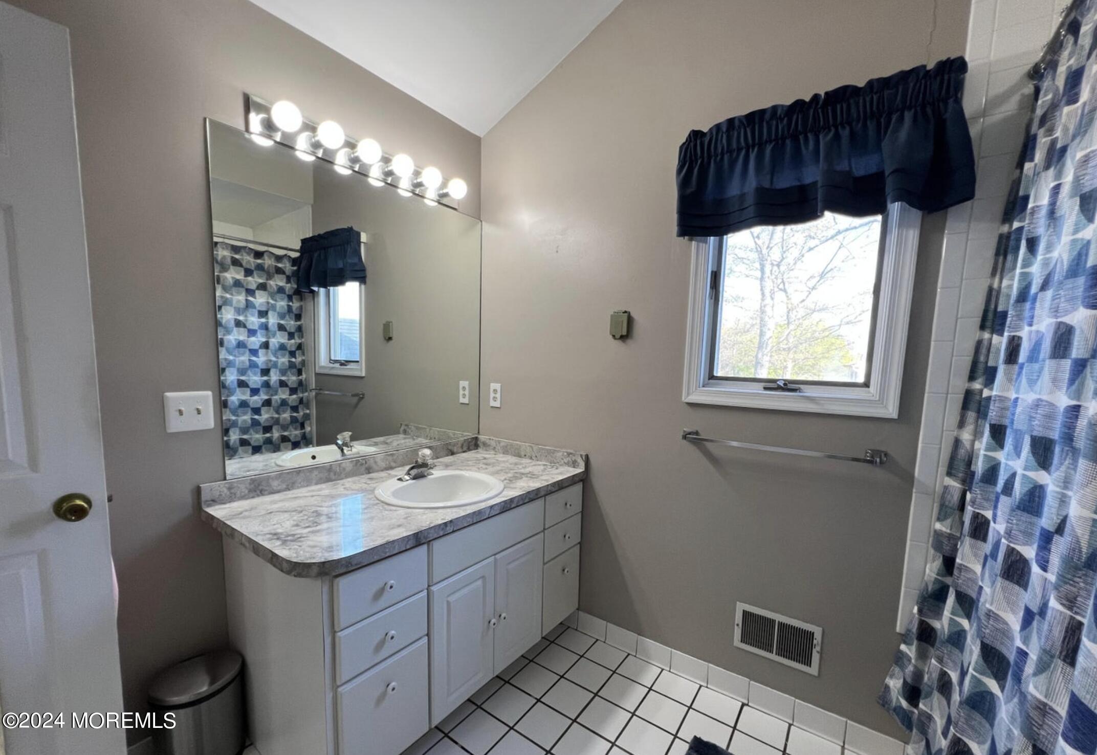 404 Drum Point Road Brick, NJ 08723 - Photo 15 of 22 a bathroom with a sink a vanity and a mirror