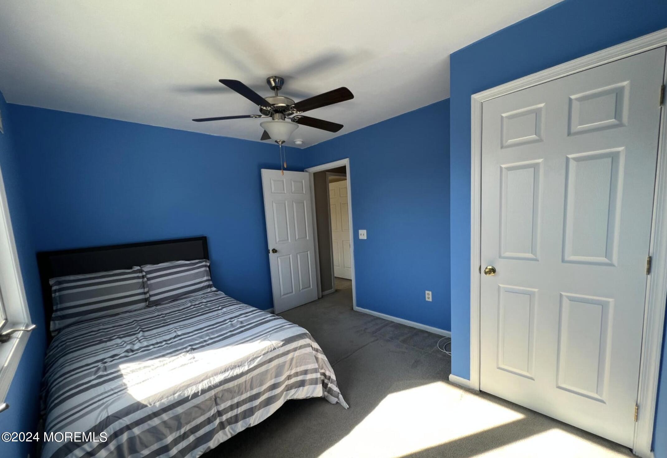 404 Drum Point Road Brick, NJ 08723 - Photo 17 of 22 a bedroom with a bed and a chandelier