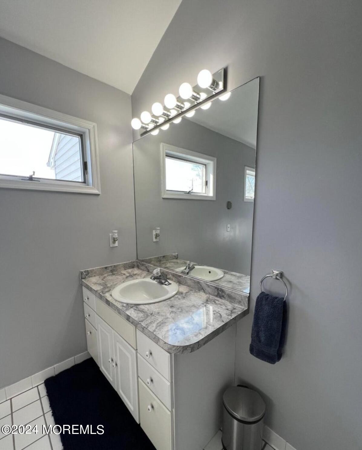 404 Drum Point Road Brick, NJ 08723 - Photo 19 of 22 a bathroom with a granite countertop sink a toilet and mirror