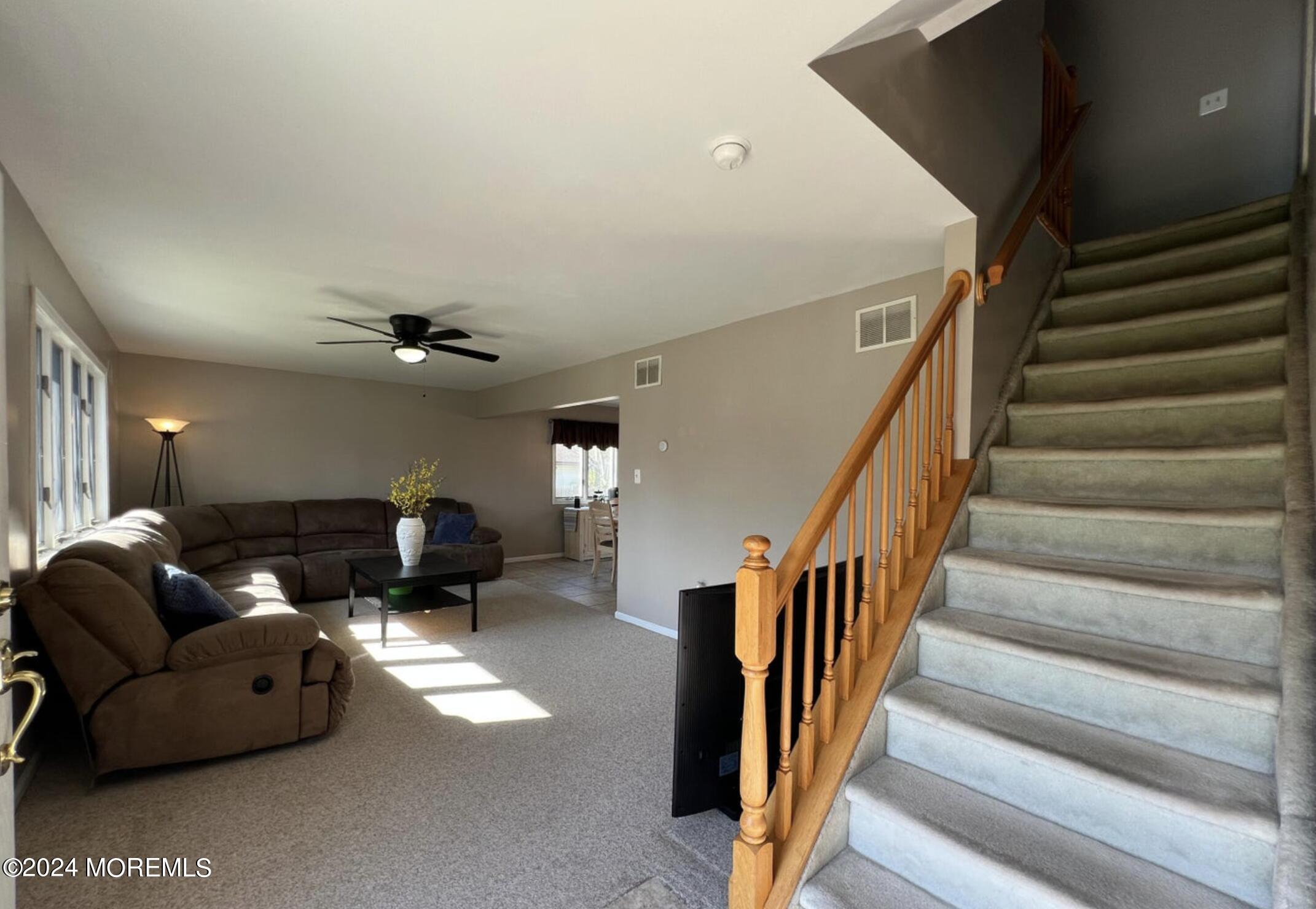 404 Drum Point Road Brick, NJ 08723 - Photo 3 of 22 a living room with furniture and stairs