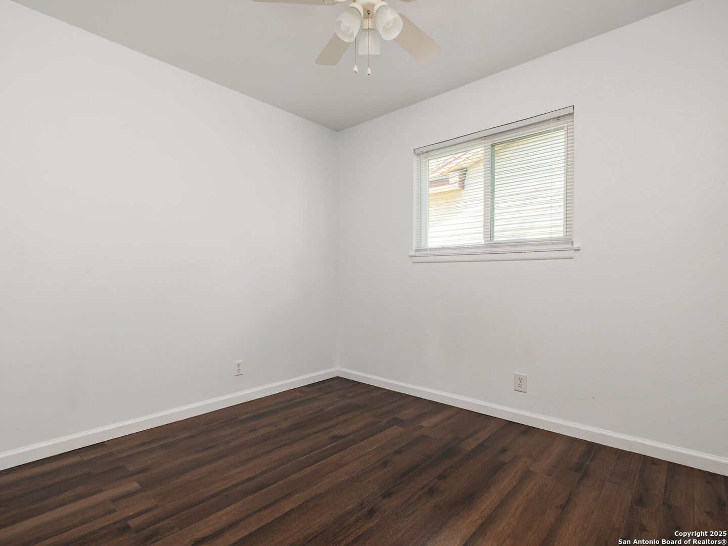 422 Bridgit Drive Converse, TX 78109 - Photo 12 of 17 an empty room with wooden floor and windows