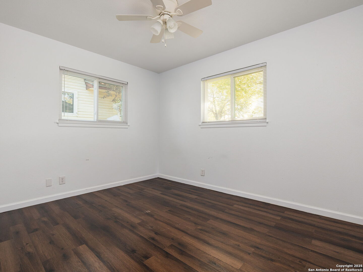 422 Bridgit Drive Converse, TX 78109 - Photo 13 of 17 a view of an empty room with wooden floor and a window