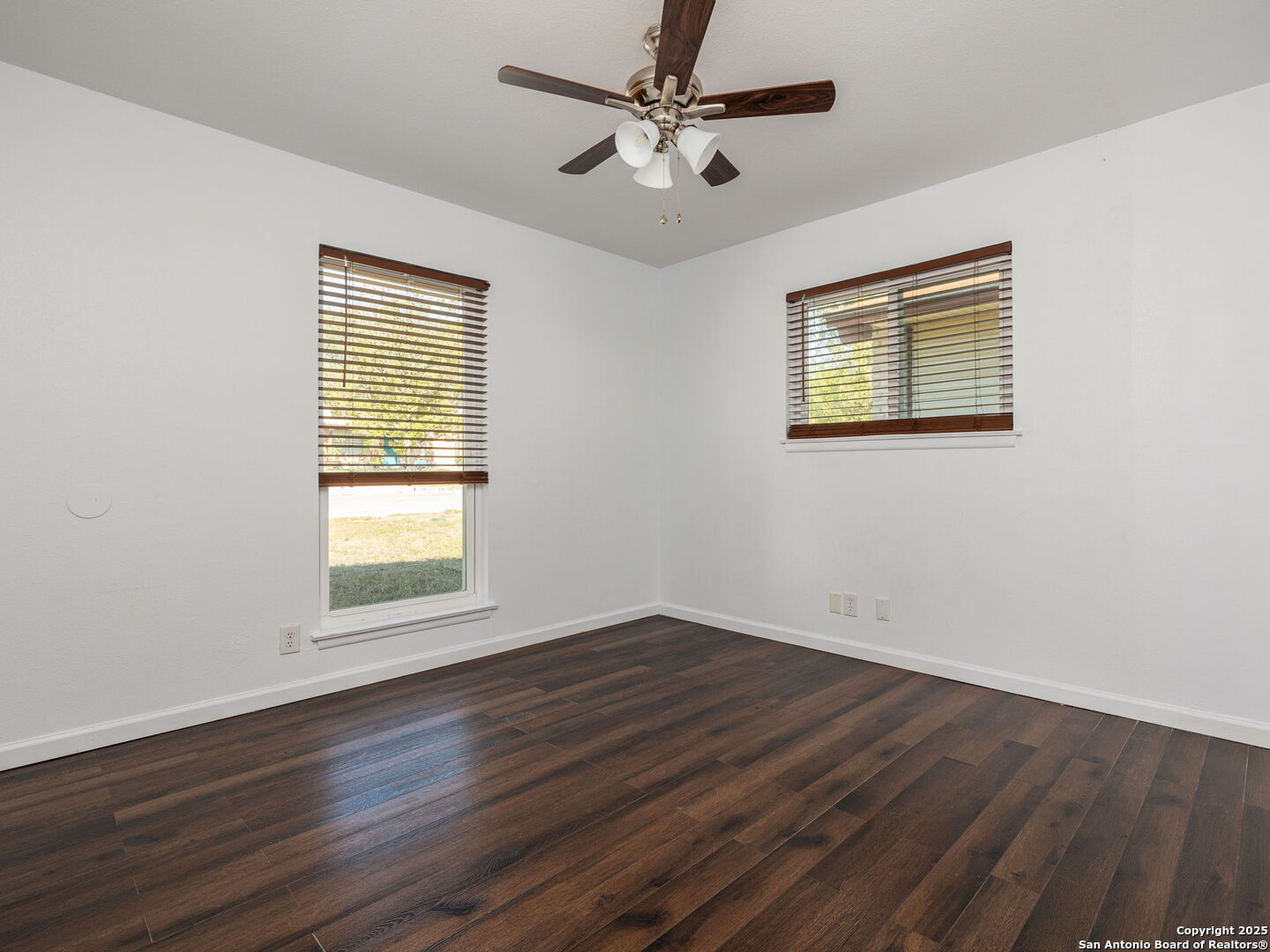 422 Bridgit Drive Converse, TX 78109 - Photo 10 of 17 a view of an empty room with wooden floor and a window