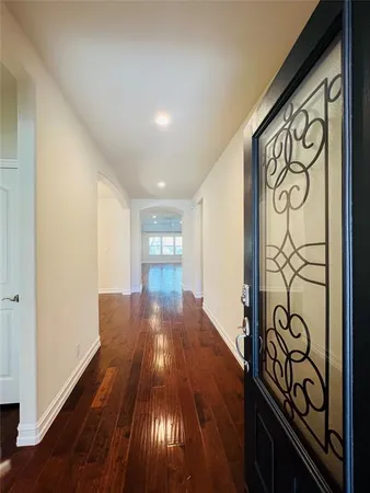 a view of a entryway with stairs and wooden floor
