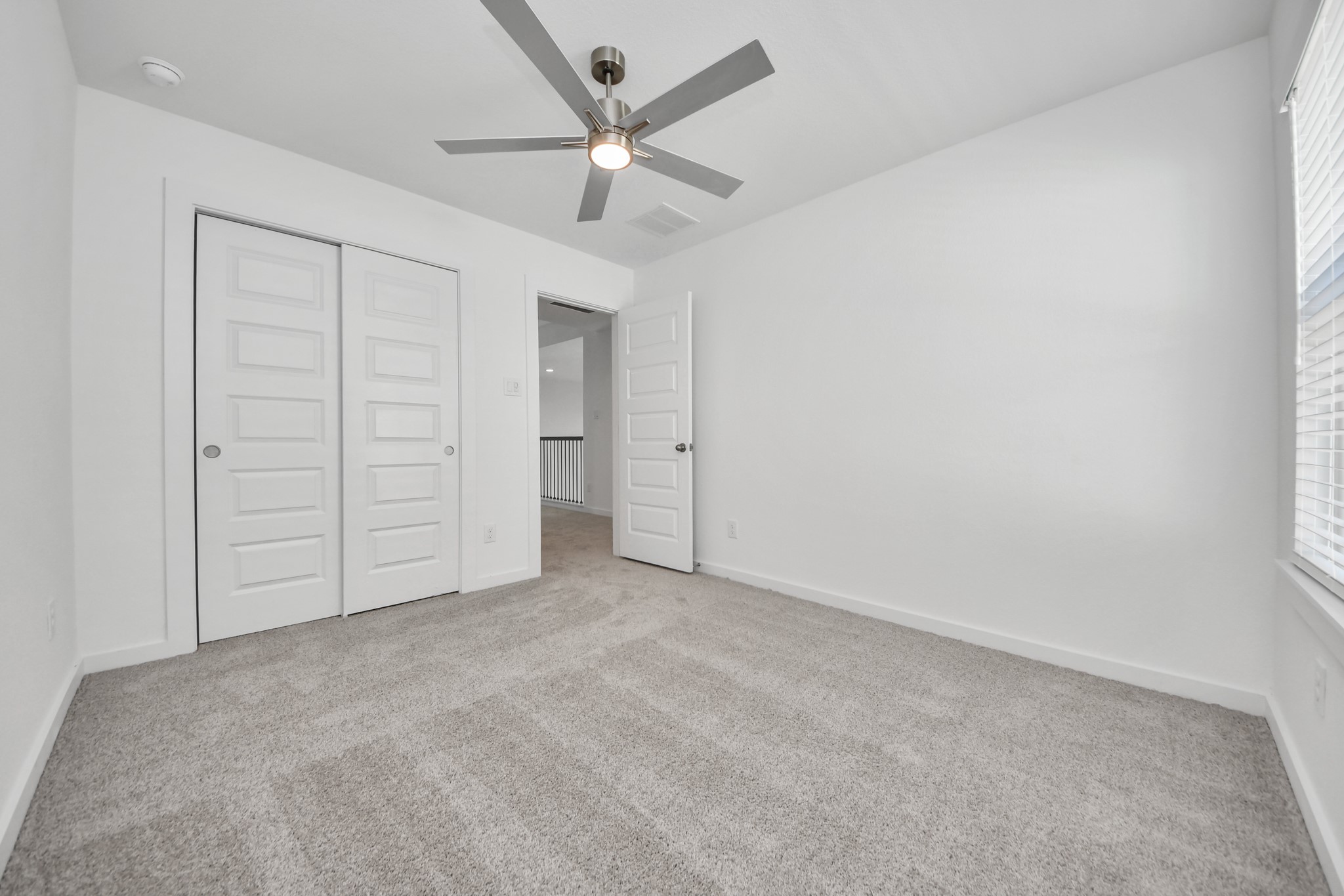 2926 Bury Park Dr Spring Spring, TX 77373 - Photo 30 of 40 Generously sized secondary bedrooms featuring spacious closets, soft and inviting carpeting underfoot, large windows allowing plenty of natural light, and the added touch of privacy blinds for your personal retreat.