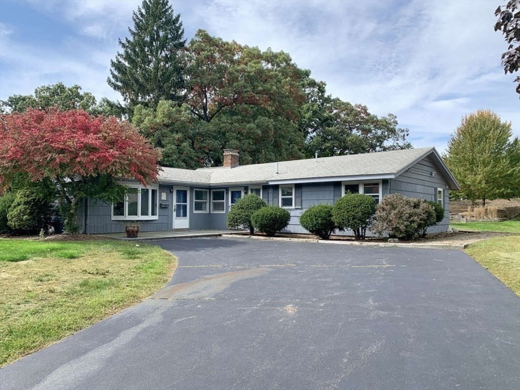 a front view of a house with a garden and porch