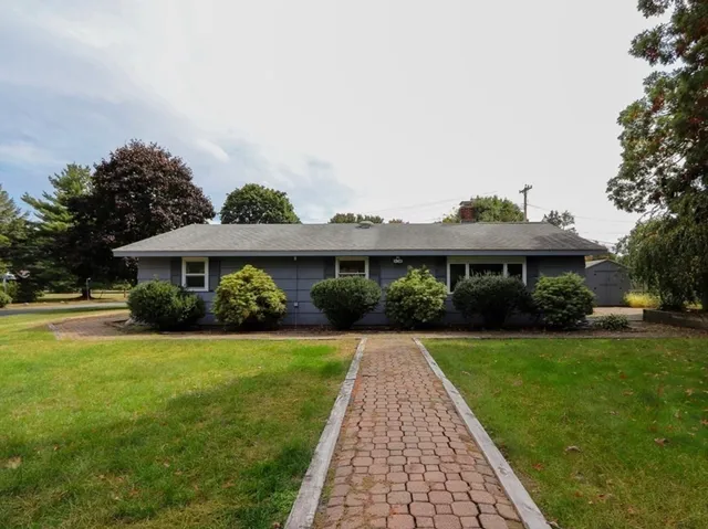 a front view of a house with garden