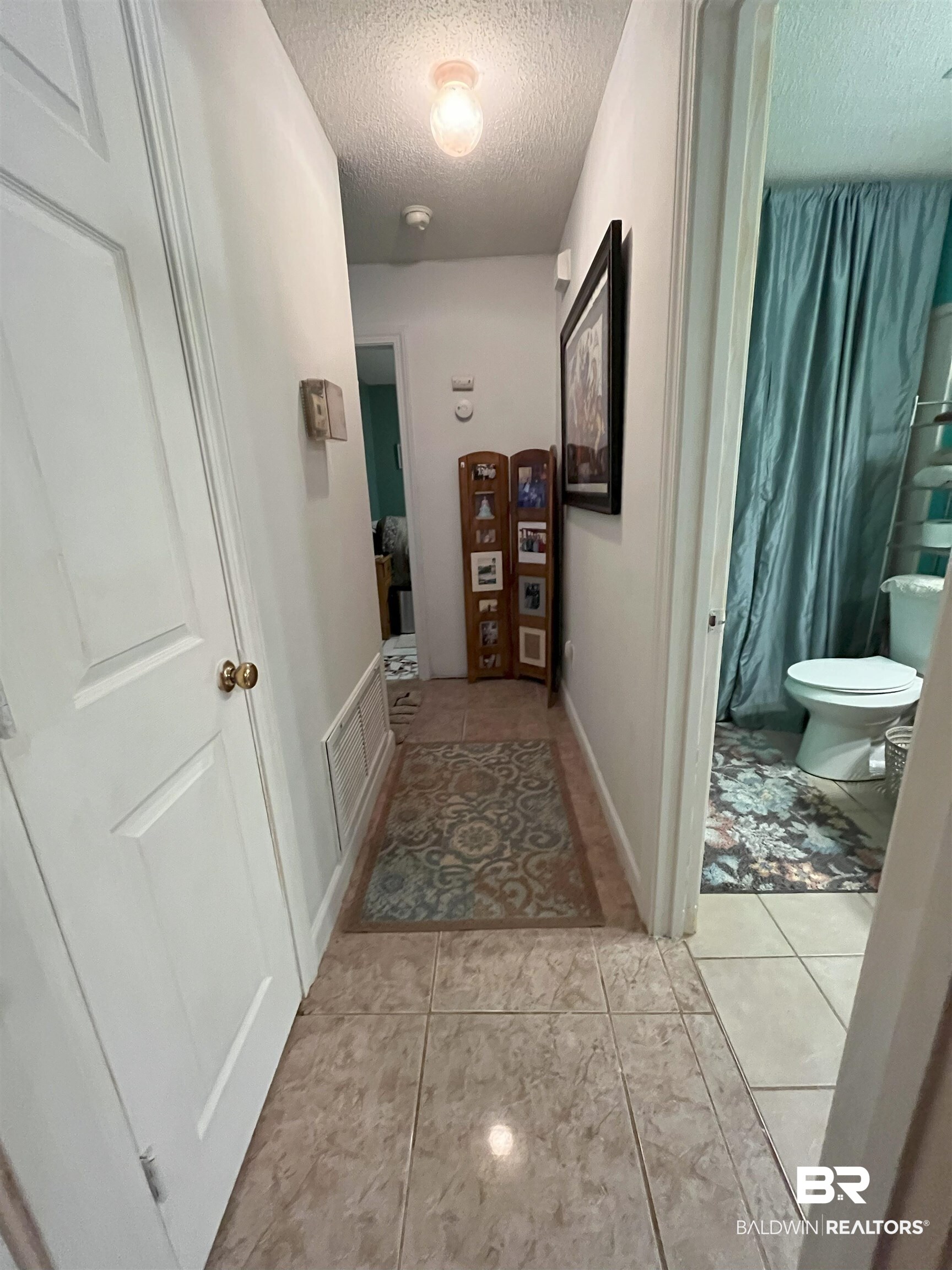 7851 Highway 98 Fairhope, AL 36532 - Photo 13 of 40 Corridor with a textured ceiling and light tile patterned floors