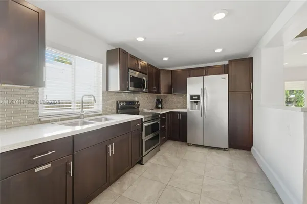 a kitchen with refrigerator cabinets and furniture