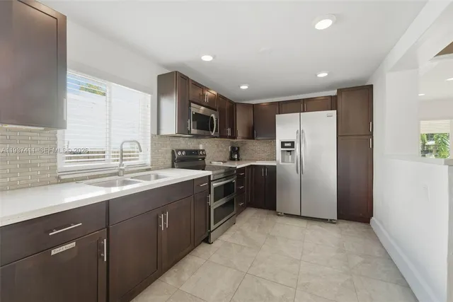 a kitchen with refrigerator cabinets and furniture