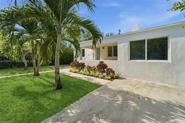 a front view of a house with a garden