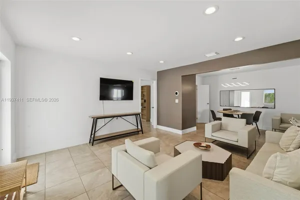 a living room with furniture and a flat screen tv