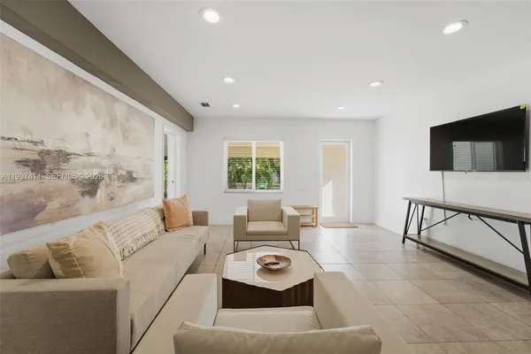 a living room with furniture and a flat screen tv