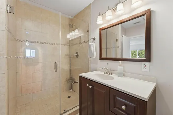 a bathroom with a sink vanity and a mirror